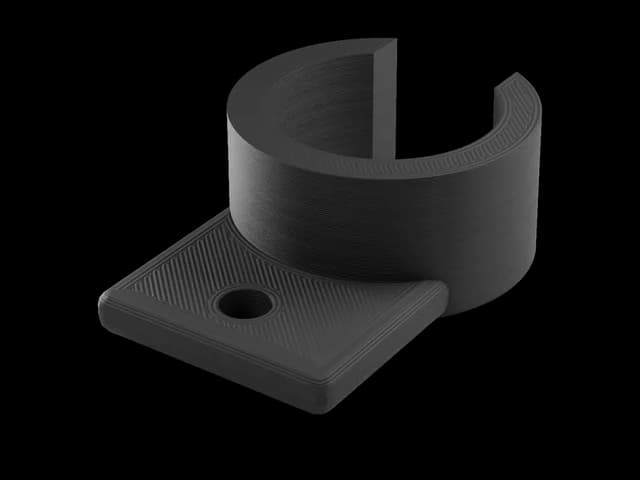 Render of a small black PETG pipe clip with a screw hole, printed layers visible